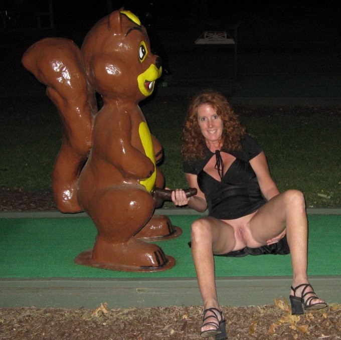 Horny wife  playing mini-golf area 