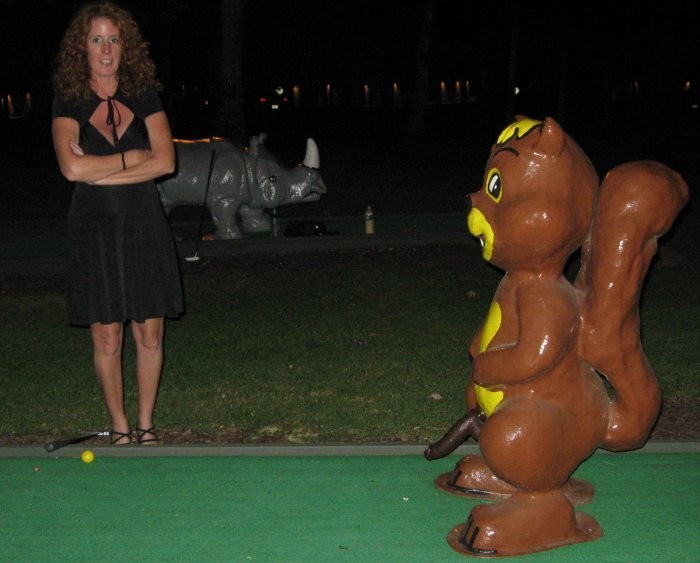 Horny wife  playing mini-golf area 