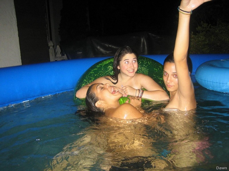 Three naked girls making fun in pool