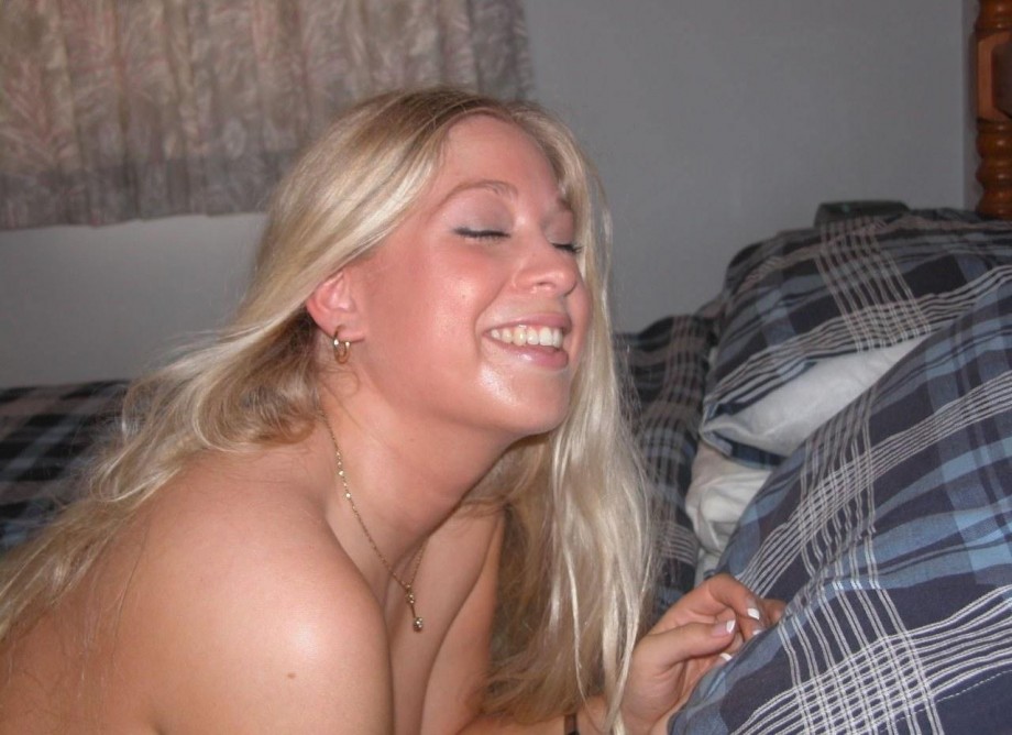 Blonde long-haired teen showing shaved pussy on bed