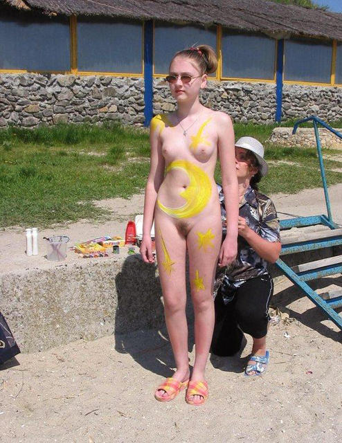 Amateur nudists and theirs beach body painting
