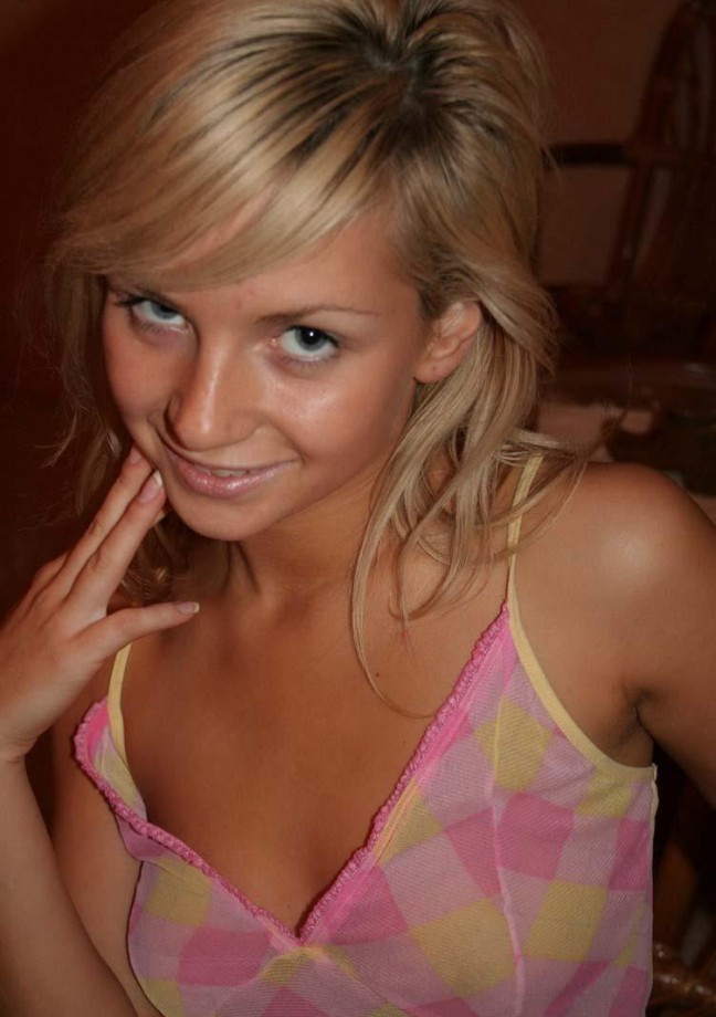 Teasing blond girlfriend stripping