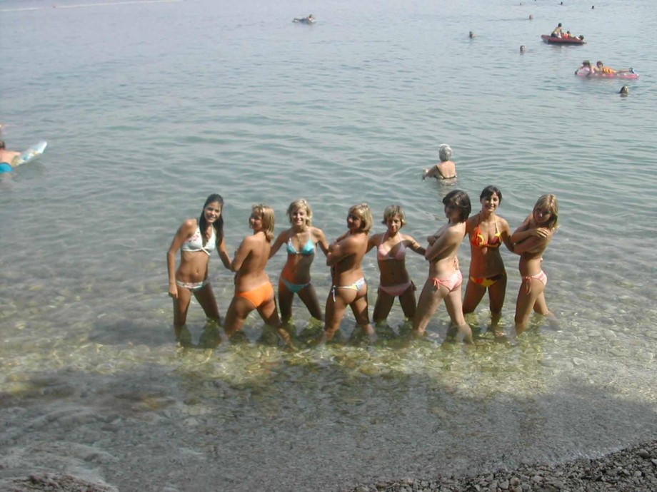 7 girls topless group shot on the beach 