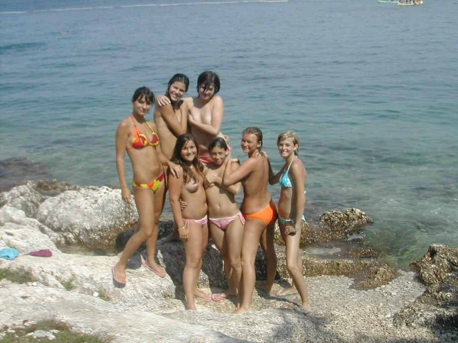 7 girls topless group shot on the beach 