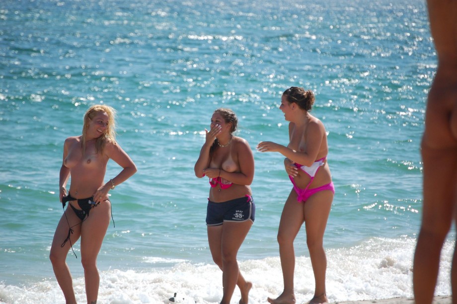 7 girls topless group shot on the beach 