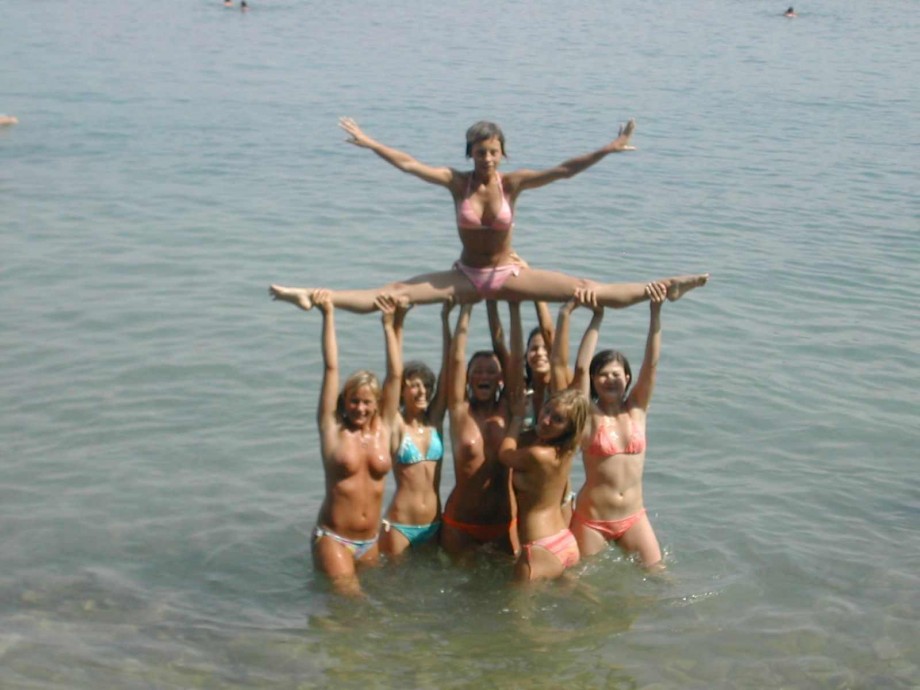 7 girls topless group shot on the beach 