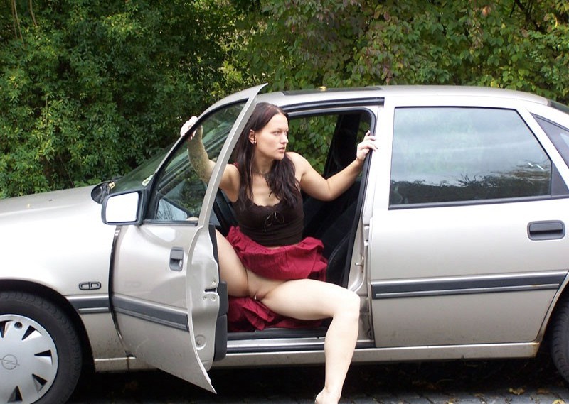 Brunette uses her toy at the car 