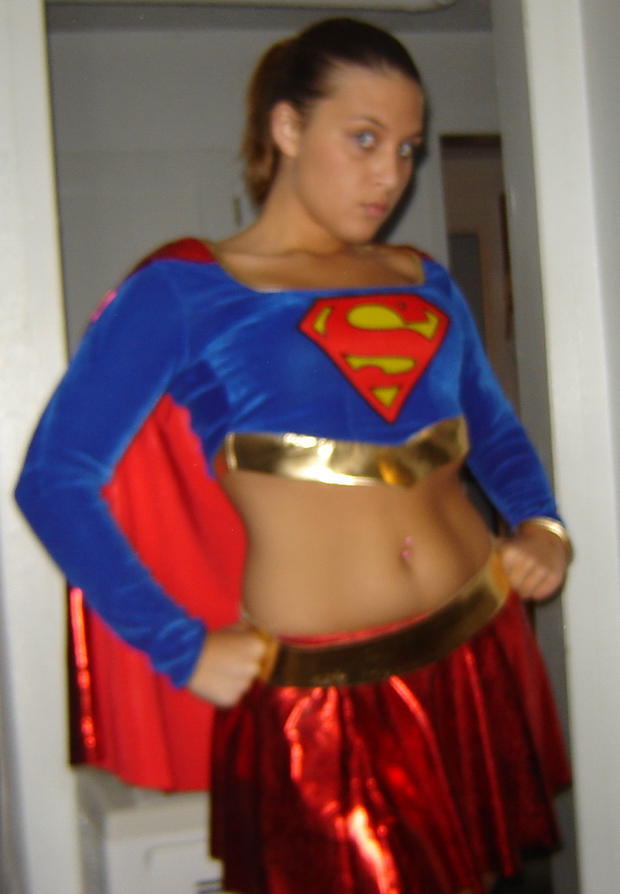 Dresses up in a supergirl outfit and masturbation