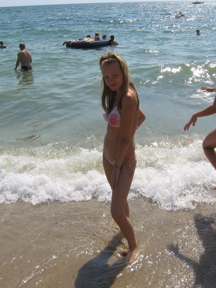 Young girls topless have a nice time on the beach 