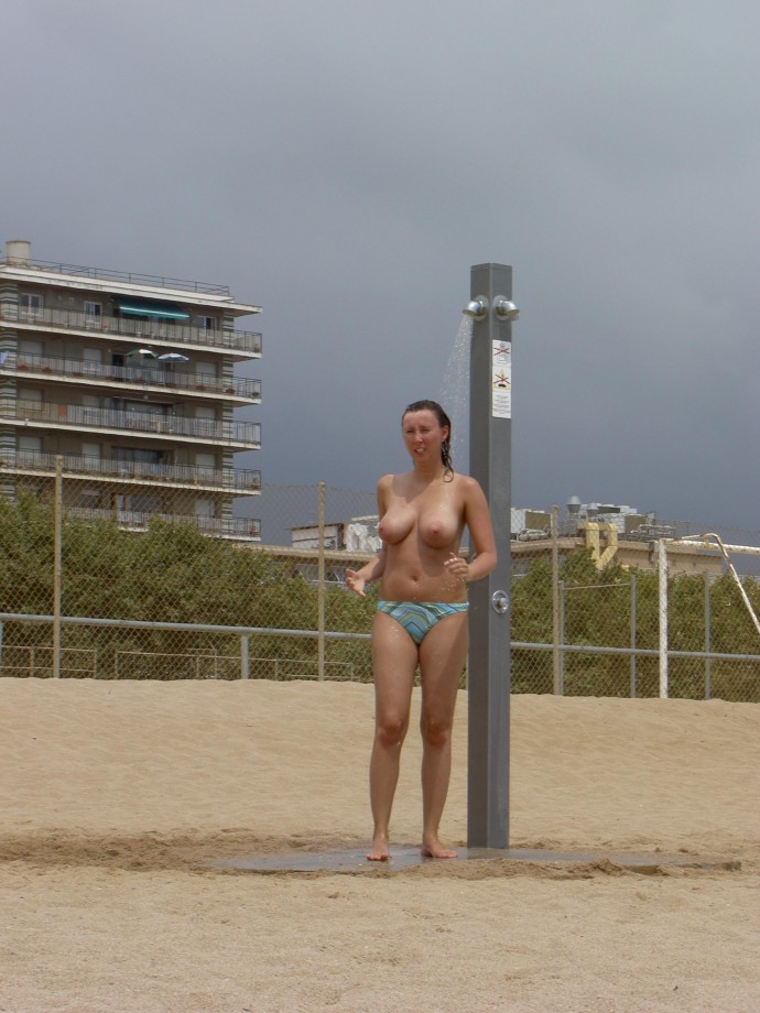 Sexy brunette with big boobs on beach holiday