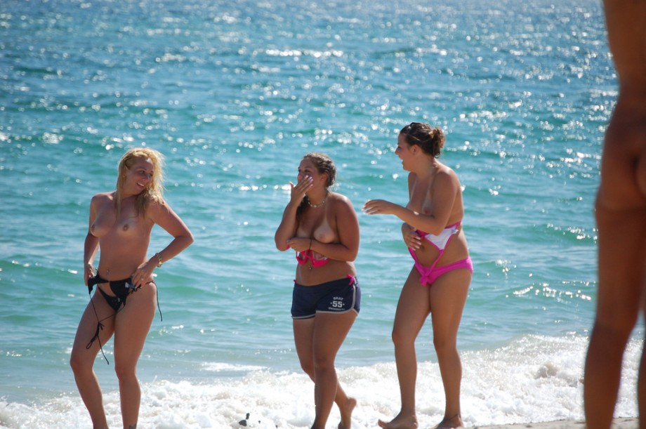 Three teen girls blend in on a nudist beach