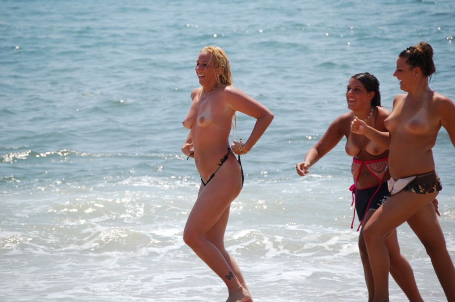 Three teen girls blend in on a nudist beach