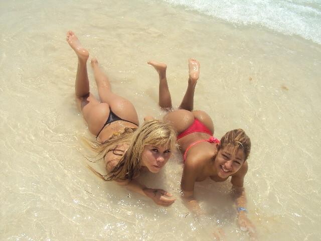 2 blonde latinas posing on the beach