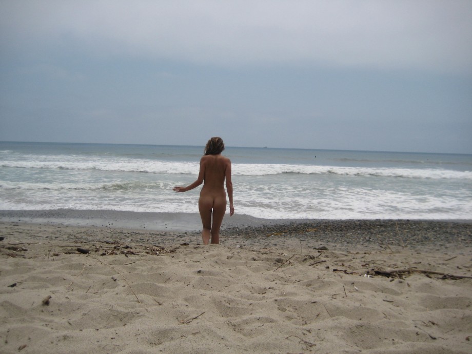 Brunette with pierced nipples on nudist beach