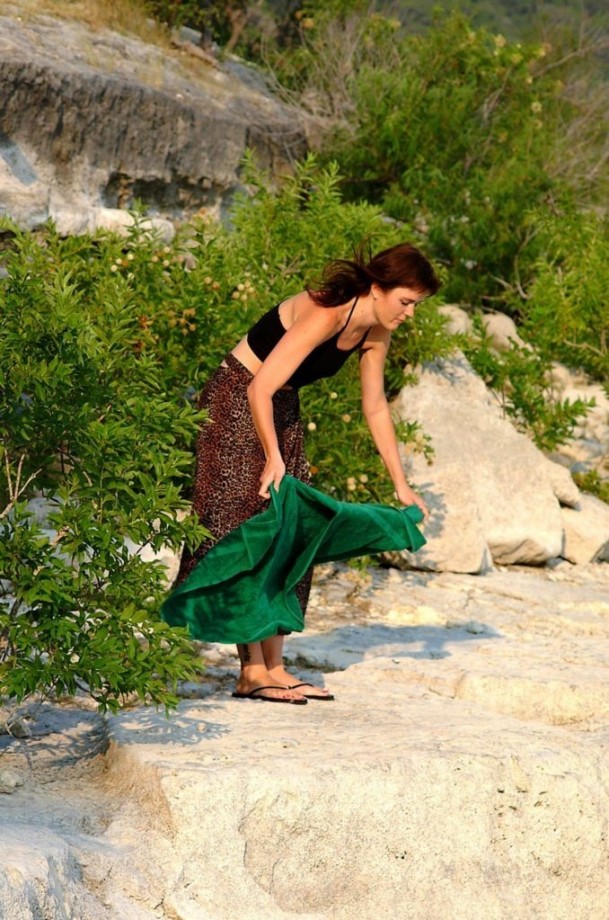 A hot girl in her late teens strips on the beach