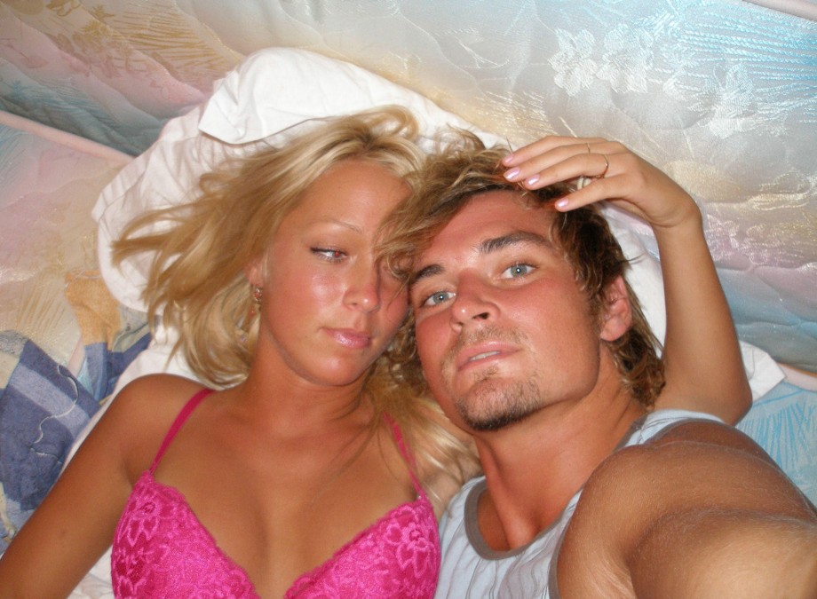 Blonde girlfriend pose on bed on vacation