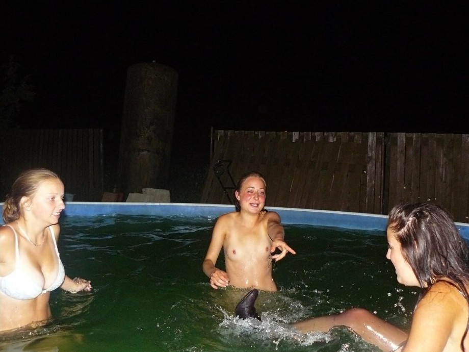 A bunch of teens jump in the pool topless