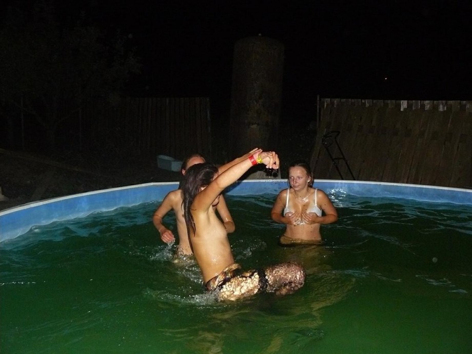 A bunch of teens jump in the pool topless