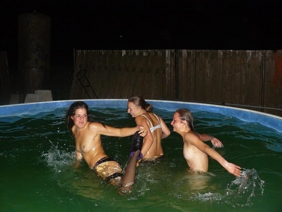 A bunch of teens jump in the pool topless