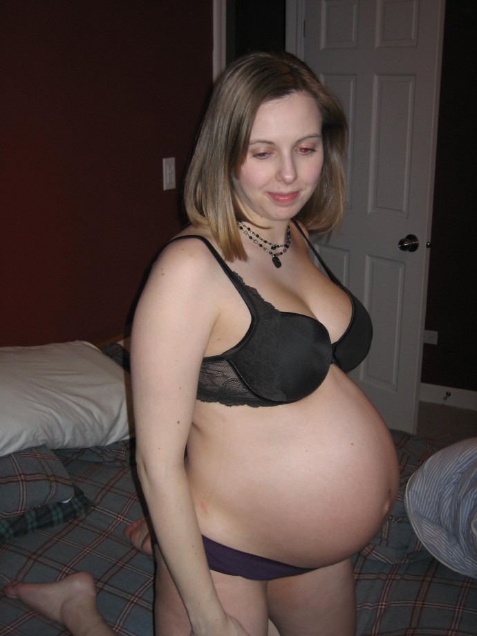 Cute pregnant blonde posing