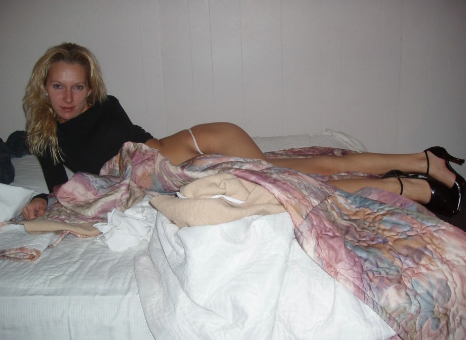 Blonde girl showing naked pussy on bed