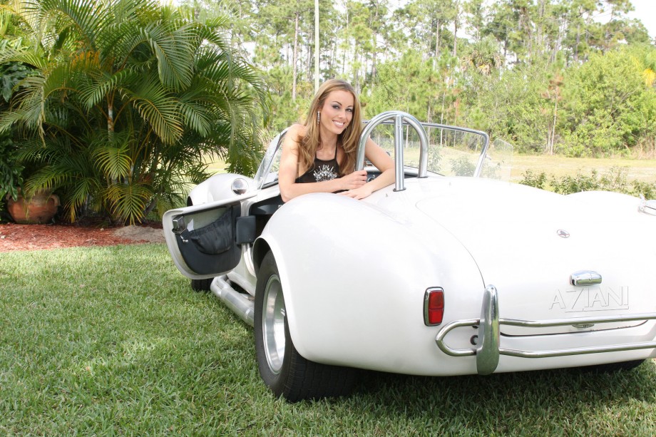 Anita dark busty babe posing on cobra car