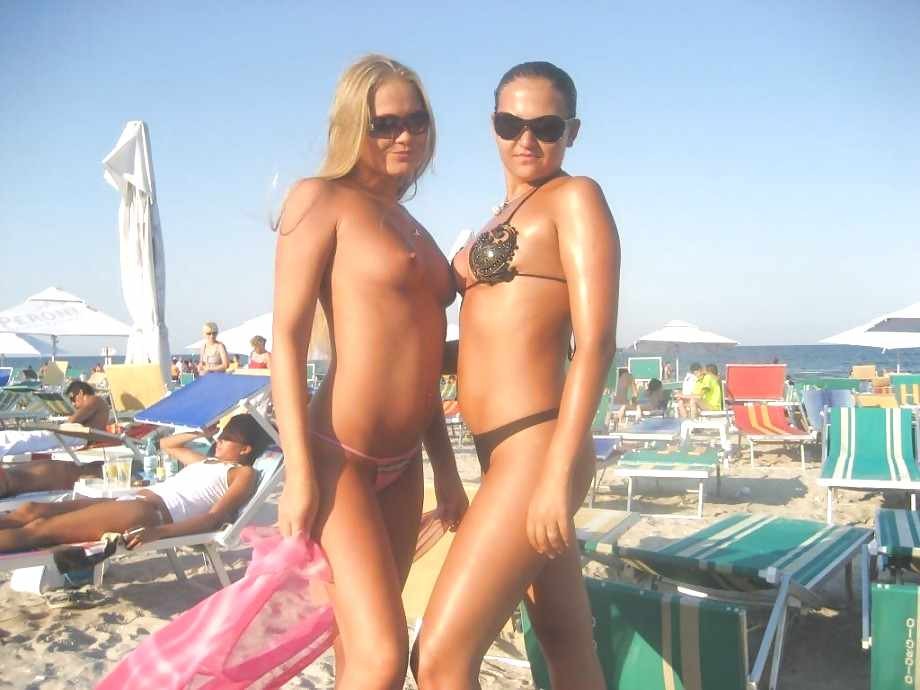 Nude or topless girls together with clothed girls