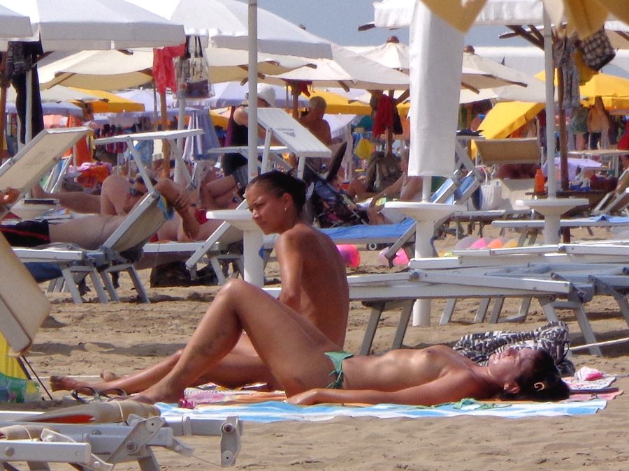 Girls sunbathing on italian beach of the adriatic coast