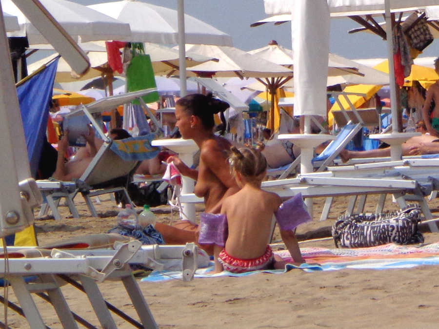 Girls sunbathing on italian beach of the adriatic coast