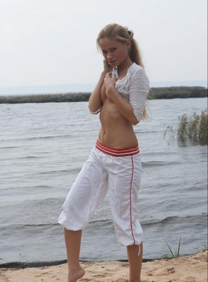 Elena stripping on the beach