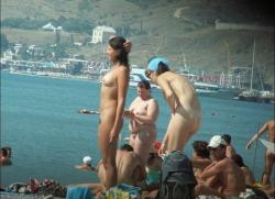 Couple of girls on busy nudist beach  5/12
