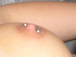 Cute chick getting her boobs pierced  9/9