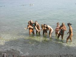 7 girls topless group shot on the beach  4/19