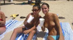 Nudist girls take a drink at the beach  48/79