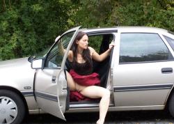 Brunette uses her toy at the car  1/5