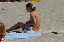 Topless teen getting changed on the beach 11/25