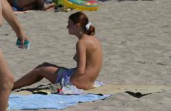 Topless teen getting changed on the beach 13/25