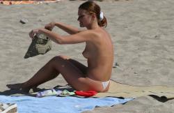 Topless teen getting changed on the beach 15/25