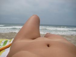 Brunette with pierced nipples on nudist beach 12/51