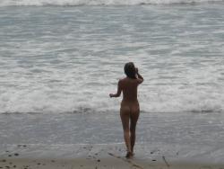 Brunette with pierced nipples on nudist beach 21/51