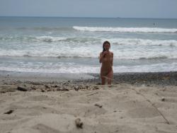 Brunette with pierced nipples on nudist beach 26/51