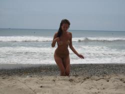 Brunette with pierced nipples on nudist beach 27/51