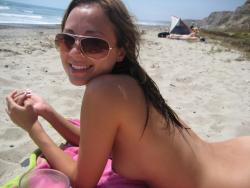 Brunette with pierced nipples on nudist beach 38/51