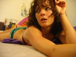 Incredibly hot brunette teen posing on a bed 12/26