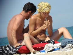 Nudist girl smoke on the beach 2/50