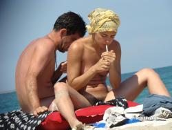 Nudist girl smoke on the beach 3/50