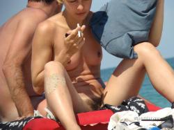 Nudist girl smoke on the beach 8/50