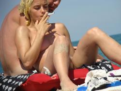 Nudist girl smoke on the beach 12/50