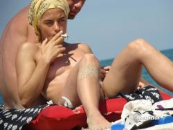 Nudist girl smoke on the beach 13/50