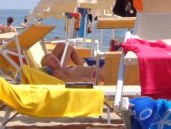 Girls sunbathing on italian beach of the adriatic coast 4/12